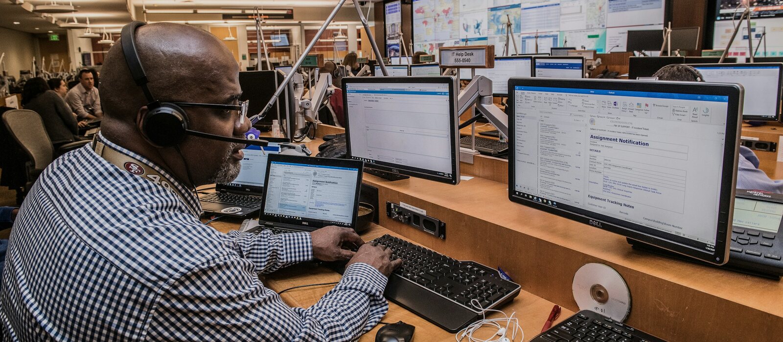 man in black and white checkered dress shirt using computer