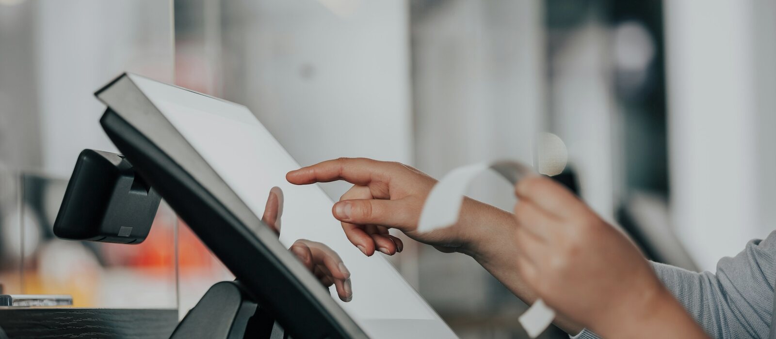 a person is using a pos machine in a store