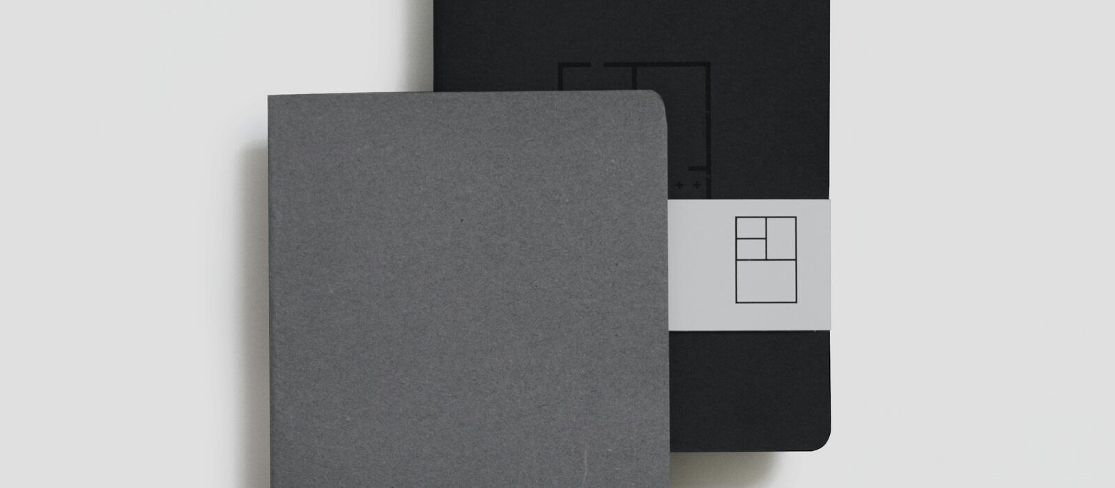 two black and gray book planners on white background
