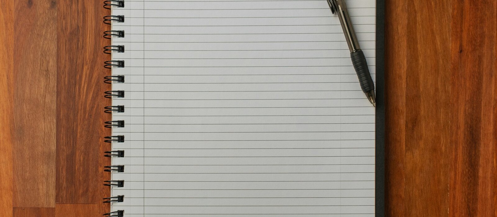black pen on white notebook