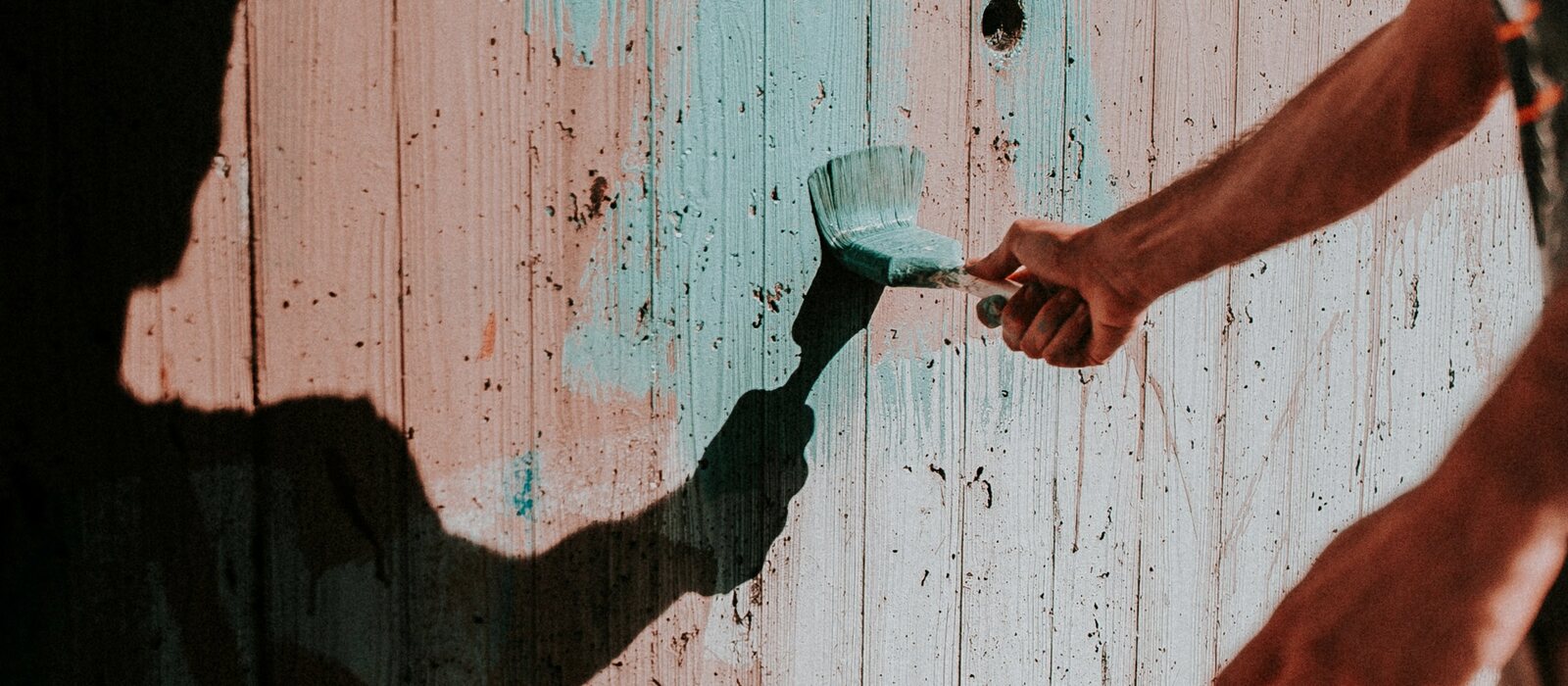 person painting wall