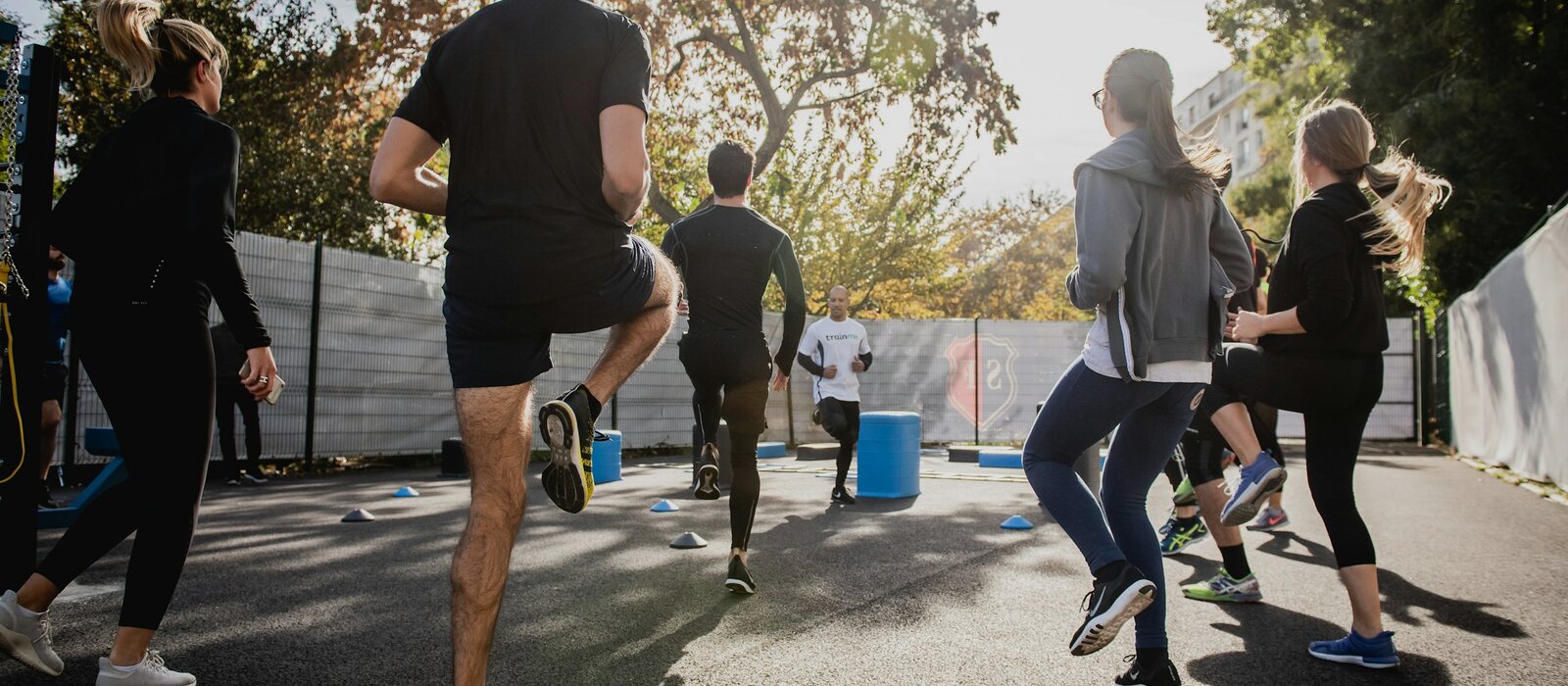 man in black t-shirt and black shorts running on road during daytime