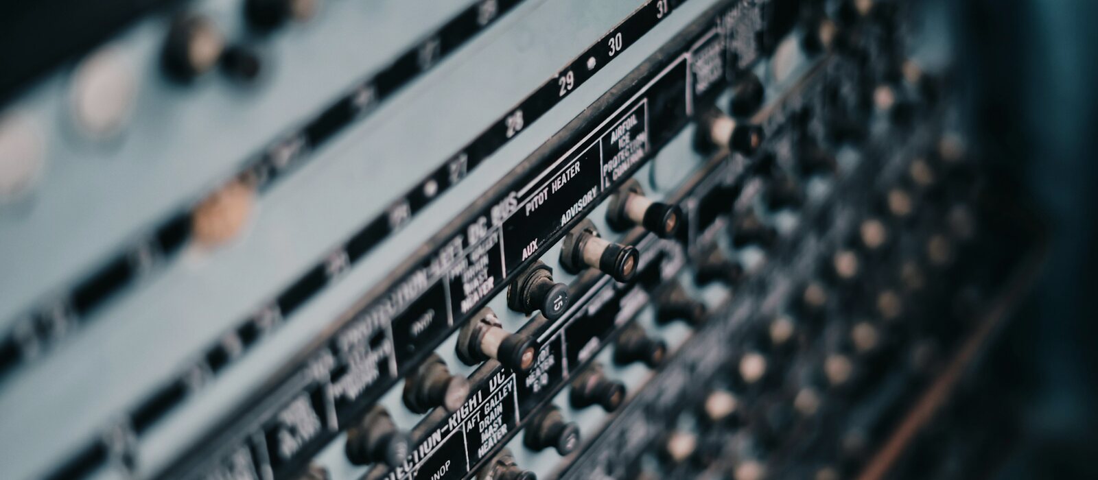a close up of a sound board with many knobs